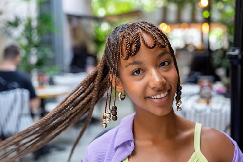 Black woman wearing long decorative braids