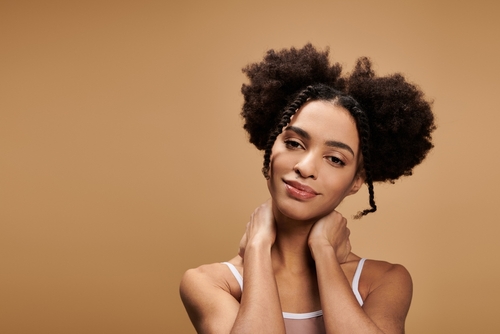 Black woman wearing natural textured puff styling