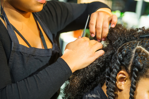 Stylist carefully sectioning textured natural hair