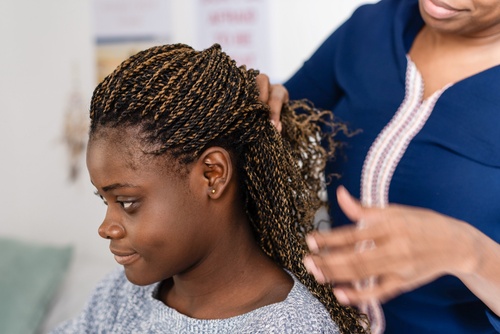 Stylist finishing a textured twist and braid look